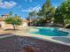 Sparkling blue community pool surrounded by lush landscaping and a tiled deck area at 2986 Juniper Hills Blvd # 202, Las Vegas, NV 89142