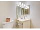 Bathroom with a single sink vanity, toilet, and modern lighting at 3063 Chapala Dr, Las Vegas, NV 89120