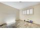This bedroom features wood-look flooring and window with shutters at 3063 Chapala Dr, Las Vegas, NV 89120