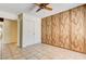 Bedroom with tile flooring, closet, wood paneling, and ceiling fan at 3063 Chapala Dr, Las Vegas, NV 89120