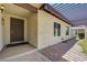 Front porch area with a dark-stained front door, stucco exterior and brick walkway at 3063 Chapala Dr, Las Vegas, NV 89120