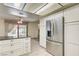 Kitchen featuring stainless steel refrigerator, island, and a view into a living room area at 3063 Chapala Dr, Las Vegas, NV 89120