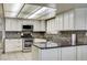 Renovated kitchen with stainless steel appliances, granite countertops, and modern backsplash at 3063 Chapala Dr, Las Vegas, NV 89120