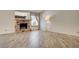 Open living room with hardwood floors, a brick fireplace, and a large window at 3063 Chapala Dr, Las Vegas, NV 89120
