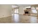 Open living room with hardwood floors, a brick fireplace, and windows overlooking the back yard at 3063 Chapala Dr, Las Vegas, NV 89120