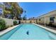 Backyard pool with dolphin mosaic tile, surrounded by lush greenery and mature trees at 3063 Chapala Dr, Las Vegas, NV 89120