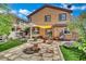 Expansive backyard featuring a covered patio, lounge furniture, stone fountain, and lush landscaping at 326 Caneflower Ct, North Las Vegas, NV 89031