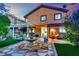 Exterior view of a home with a spacious backyard featuring a lounge area and a beautiful stone fountain at 326 Caneflower Ct, North Las Vegas, NV 89031