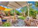 Charming backyard with covered patio, comfortable seating, fountain, and lush greenery at 326 Caneflower Ct, North Las Vegas, NV 89031