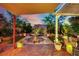 Scenic backyard featuring a stone water fountain, elegant patio furniture, and meticulously maintained greenery at 326 Caneflower Ct, North Las Vegas, NV 89031