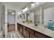 Bathroom features a double sink vanity with a large mirror and plenty of counter space at 326 Caneflower Ct, North Las Vegas, NV 89031