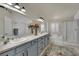 Bright bathroom featuring double sinks, bathtub, and glass door shower at 326 Caneflower Ct, North Las Vegas, NV 89031