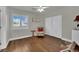 Inviting bedroom with wood floors, neutral walls, ceiling fan, and shutters at 326 Caneflower Ct, North Las Vegas, NV 89031