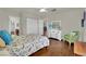 Spacious bedroom featuring hardwood floors, dresser, chair, and abundant natural light at 326 Caneflower Ct, North Las Vegas, NV 89031
