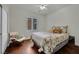 Bright bedroom features hardwood floors, plantation shutters, and a comfortable seating area at 326 Caneflower Ct, North Las Vegas, NV 89031