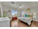 Bright bedroom with hardwood flooring, ceiling fan, shutters, and stylish decor at 326 Caneflower Ct, North Las Vegas, NV 89031