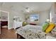 Charming bedroom with ceiling fan, wood floors, dresser, and view to a comfortably furnished sitting room at 326 Caneflower Ct, North Las Vegas, NV 89031