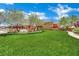 A well-manicured common area with green grass, playground, and walking paths at 326 Caneflower Ct, North Las Vegas, NV 89031