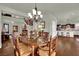Bright dining room featuring a classic chandelier and hardwood floors at 326 Caneflower Ct, North Las Vegas, NV 89031