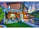Outdoor living space with an inviting lounge area, perfect for relaxation, with a stone fountain and landscaped yard at 326 Caneflower Ct, North Las Vegas, NV 89031