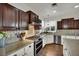 This modern kitchen features stainless steel appliances, granite countertops and tile backsplash at 326 Caneflower Ct, North Las Vegas, NV 89031