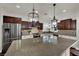 Gourmet kitchen with stainless appliances, expansive granite counters, and bright lighting at 326 Caneflower Ct, North Las Vegas, NV 89031