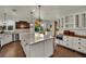 Updated kitchen featuring a large island, stainless steel appliances, and backyard views at 326 Caneflower Ct, North Las Vegas, NV 89031
