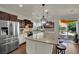 Well-lit kitchen showcasing a large island, stainless steel appliances, and backyard access at 326 Caneflower Ct, North Las Vegas, NV 89031