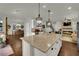 Open kitchen and dining area with island, fireplace, hardwood floors and stainless appliances at 326 Caneflower Ct, North Las Vegas, NV 89031