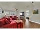 Inviting living room features a plush red sectional and hardwood floors at 326 Caneflower Ct, North Las Vegas, NV 89031