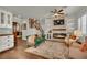Inviting living room with a stone fireplace, hardwood floors, and comfortable seating at 326 Caneflower Ct, North Las Vegas, NV 89031