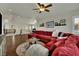 Bright living room with large red sectional sofa and an area rug at 326 Caneflower Ct, North Las Vegas, NV 89031