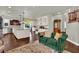 Open concept living space with kitchen, stairs, and sofa with patterned rug at 326 Caneflower Ct, North Las Vegas, NV 89031