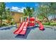 Community playground featuring a slide and other play structures for recreation at 326 Caneflower Ct, North Las Vegas, NV 89031