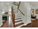 Inviting staircase features wood treads, white risers, and a stained wood railing at 326 Caneflower Ct, North Las Vegas, NV 89031