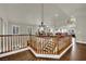 Upstairs hallway overlooking main living areas features wood railing and chandelier at 326 Caneflower Ct, North Las Vegas, NV 89031