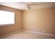 Bright bedroom featuring tile flooring, a ceiling fan, and a window allowing natural light at 3260 N Heritage Way, Las Vegas, NV 89121