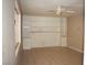 Spacious living room featuring tile flooring, built-in shelving, and a ceiling fan at 3260 N Heritage Way, Las Vegas, NV 89121