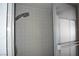 Shower with gray tiles and a glass sliding door at 3260 N Heritage Way, Las Vegas, NV 89121