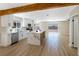 Open kitchen with stainless steel appliances, white cabinetry, and access to the backyard at 356 Gulfport Ct, Las Vegas, NV 89145