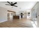 Open concept kitchen with white cabinets, center island, stainless steel appliances, and wood-look flooring at 356 Gulfport Ct, Las Vegas, NV 89145