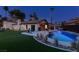 Expansive backyard features pool, covered patio, lush greenery, and inviting lounge area at 3708 Lorraine Ln, Las Vegas, NV 89120