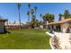 Inviting backyard with an artificial lawn, mature trees, and an outdoor dining set, great for entertaining and relaxing at 3708 Lorraine Ln, Las Vegas, NV 89120