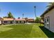 Lush backyard with a well-kept lawn, mature trees, and a small building, creating a private and serene outdoor space at 3708 Lorraine Ln, Las Vegas, NV 89120