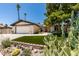 Welcoming home boasts xeriscaping, front lawn, and a large two-car garage with ample driveway parking at 3708 Lorraine Ln, Las Vegas, NV 89120