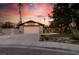 Charming home with a spacious driveway, two-car garage and well-maintained desert landscaping at sunset at 3708 Lorraine Ln, Las Vegas, NV 89120