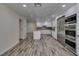 Open kitchen with stainless steel appliances, white cabinetry, and granite countertops at 3708 Lorraine Ln, Las Vegas, NV 89120