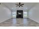 Bright, expansive living room featuring wood-look floors, large windows, and a stylish brick fireplace at 3708 Lorraine Ln, Las Vegas, NV 89120