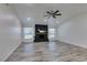 Bright living room featuring brick fireplace, ceiling fan, and plank flooring at 3708 Lorraine Ln, Las Vegas, NV 89120