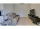 Neutral living room featuring a sofa, entertainment center and sleek flooring at 3708 Lorraine Ln, Las Vegas, NV 89120